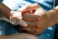 Couple clasping hands