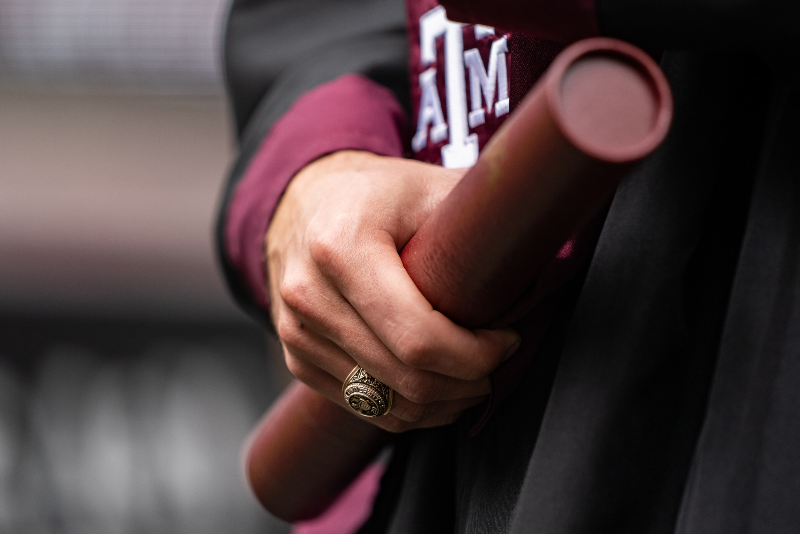 Student holding a diploma at Texas A&M University commencement ceremony at Kyle Field on March 12, 2021, in College Station, Texas. by Jesse Everett with Texas A&M University